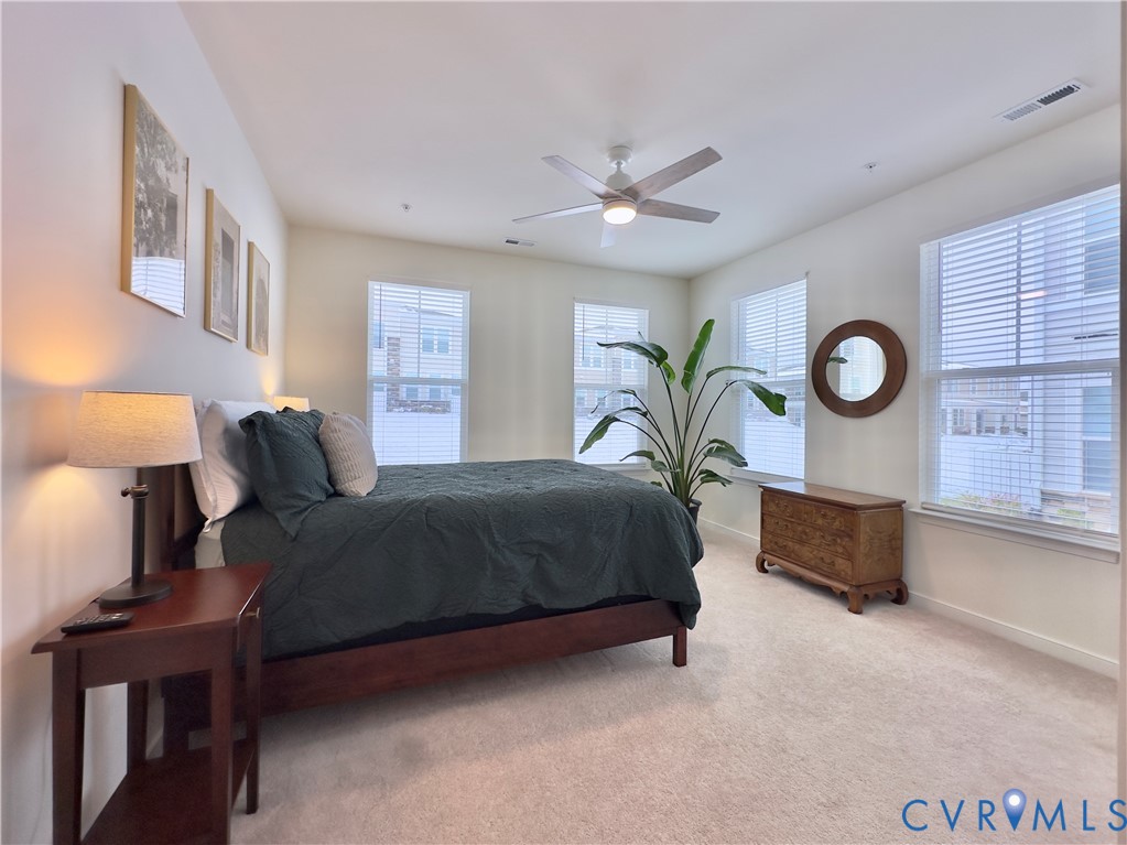 12423 Wescott Avenue Midlothian, VA 23112 - Photo 19 of 25 a spacious bedroom with a bed and a lamp on a table