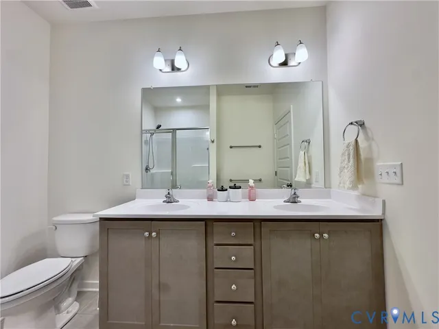 a living room with furniture a flat screen tv and a window