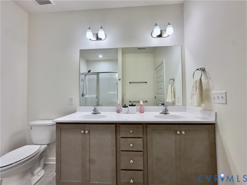12423 Wescott Avenue Midlothian, VA 23112 - Photo 20 of 25 a bathroom with a granite countertop sink and a mirror