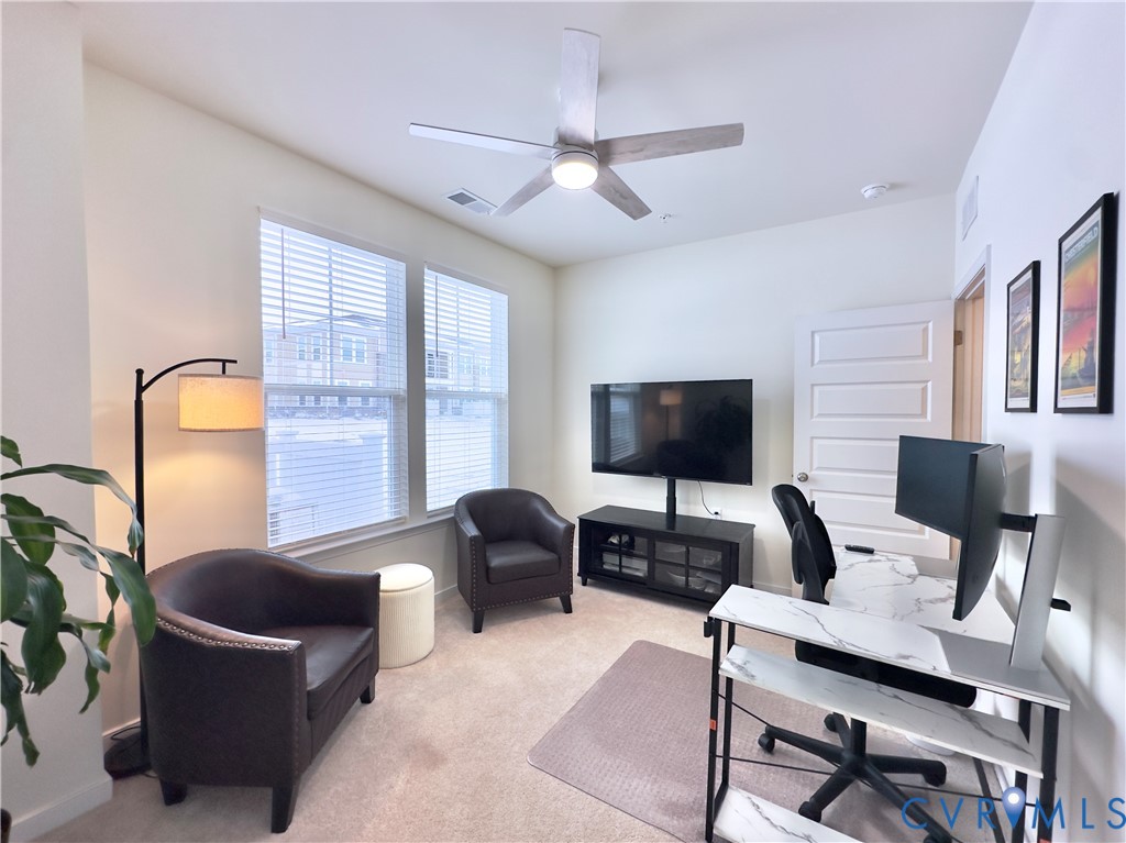 12423 Wescott Avenue Midlothian, VA 23112 - Photo 21 of 25 a living room with furniture a flat screen tv and a window