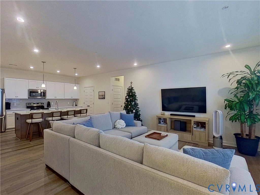 12423 Wescott Avenue Midlothian, VA 23112 - Photo 3 of 25 a living room with furniture a flat screen tv and a fireplace