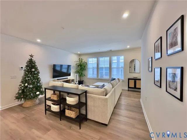 a living room with furniture a large window and a fireplace