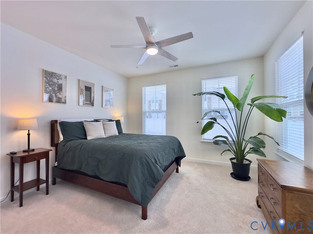12423 Wescott Avenue Midlothian, VA 23112 - Photo 7 of 25 a bedroom with a bed a couch and a potted plant