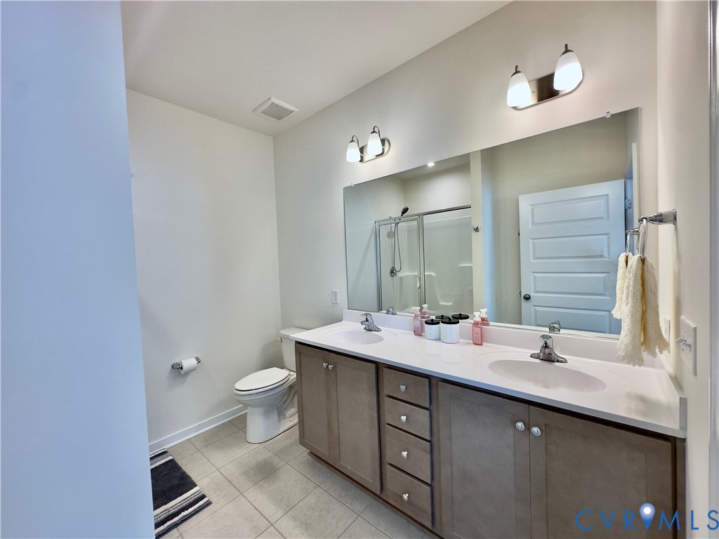 12423 Wescott Avenue Midlothian, VA 23112 - Photo 9 of 25 a bathroom with a double vanity sink toilet and a mirror