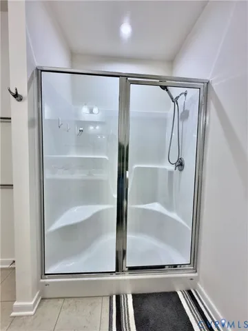 a bathroom with a glass shower door