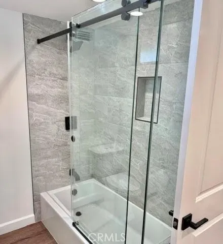 a bathroom with a tub and shower