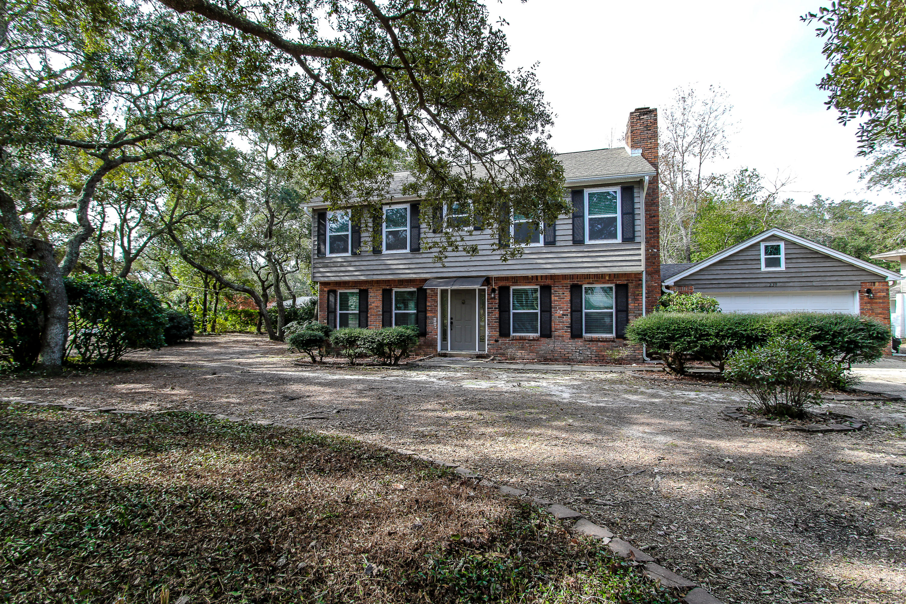 237 Country Club Road Shalimar, FL 32579 - Photo 1 of 74 a front view of a house with a yard and garage