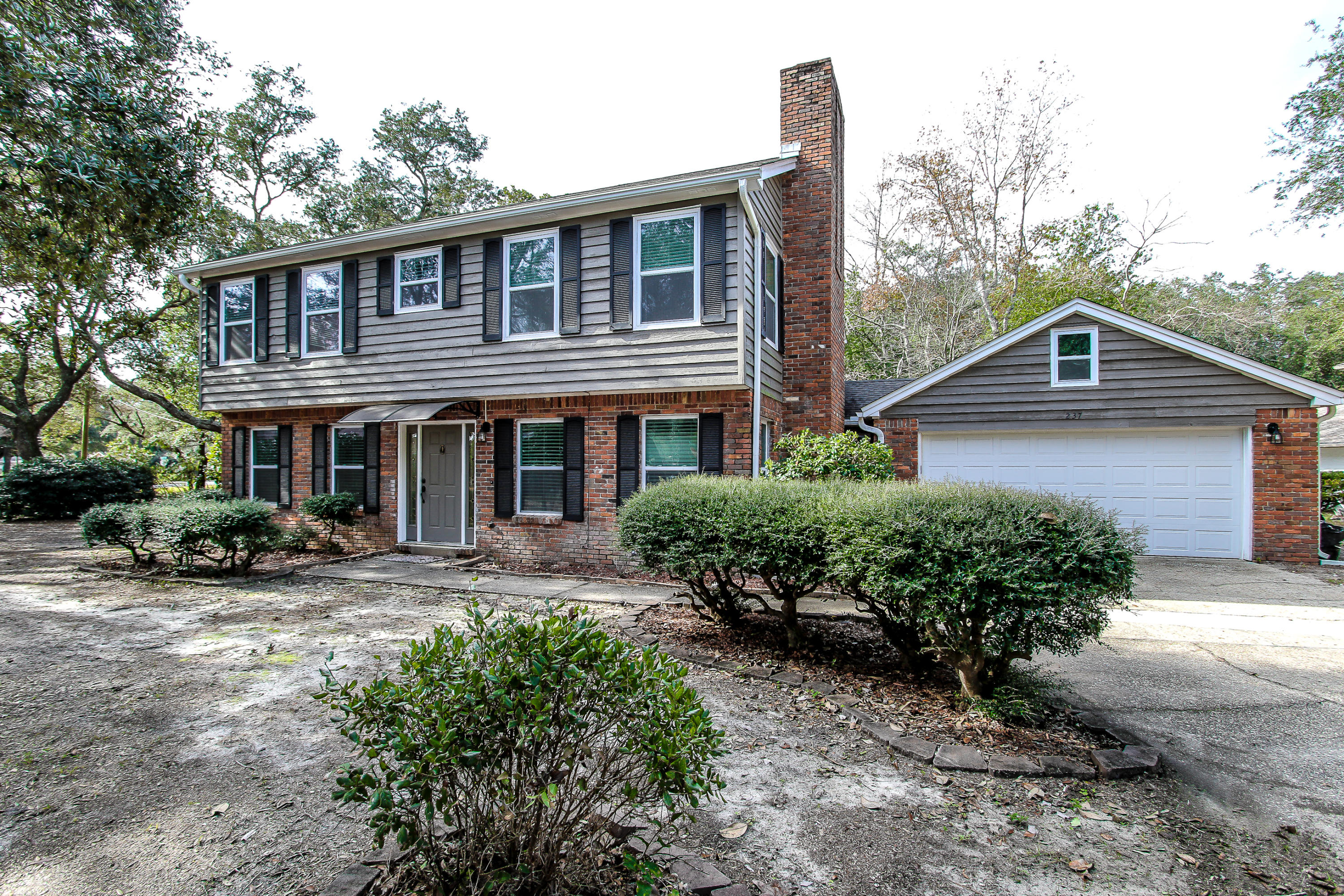 237 Country Club Road Shalimar, FL 32579 - Photo 2 of 74 a front view of a house with a yard
