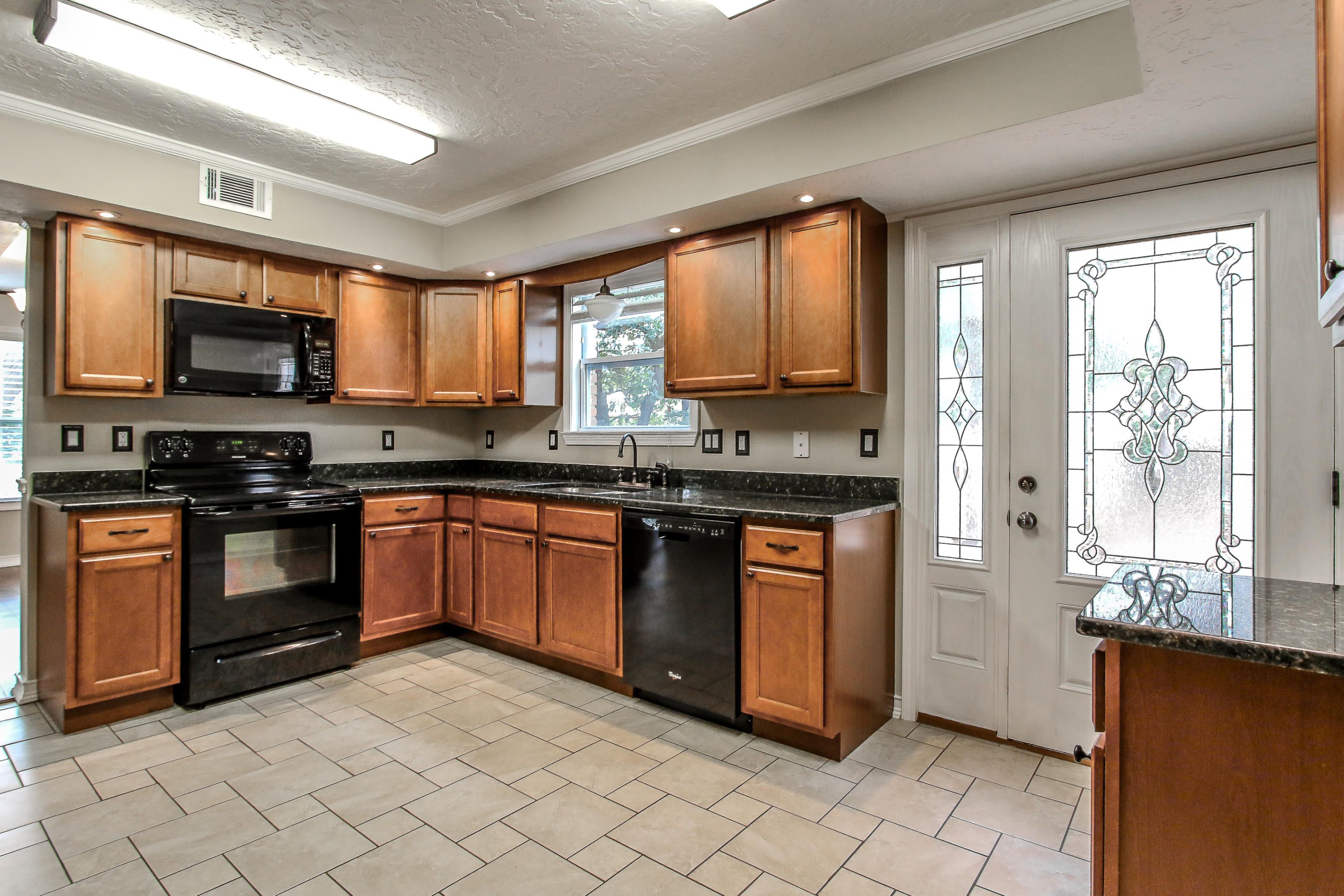 237 Country Club Road Shalimar, FL 32579 - Photo 30 of 74 a kitchen with stainless steel appliances granite countertop a stove a sink and a microwave