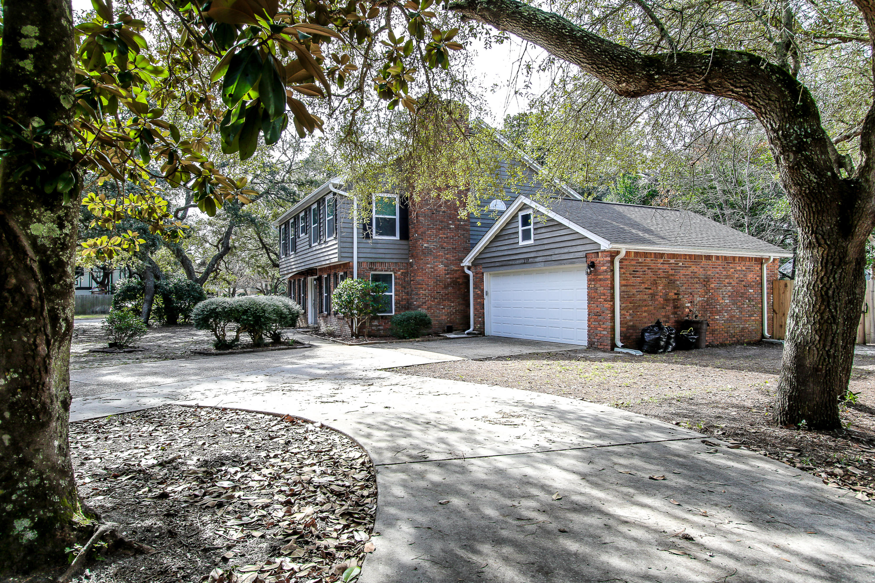237 Country Club Road Shalimar, FL 32579 - Photo 3 of 74 a front view of a house with a yard and garage