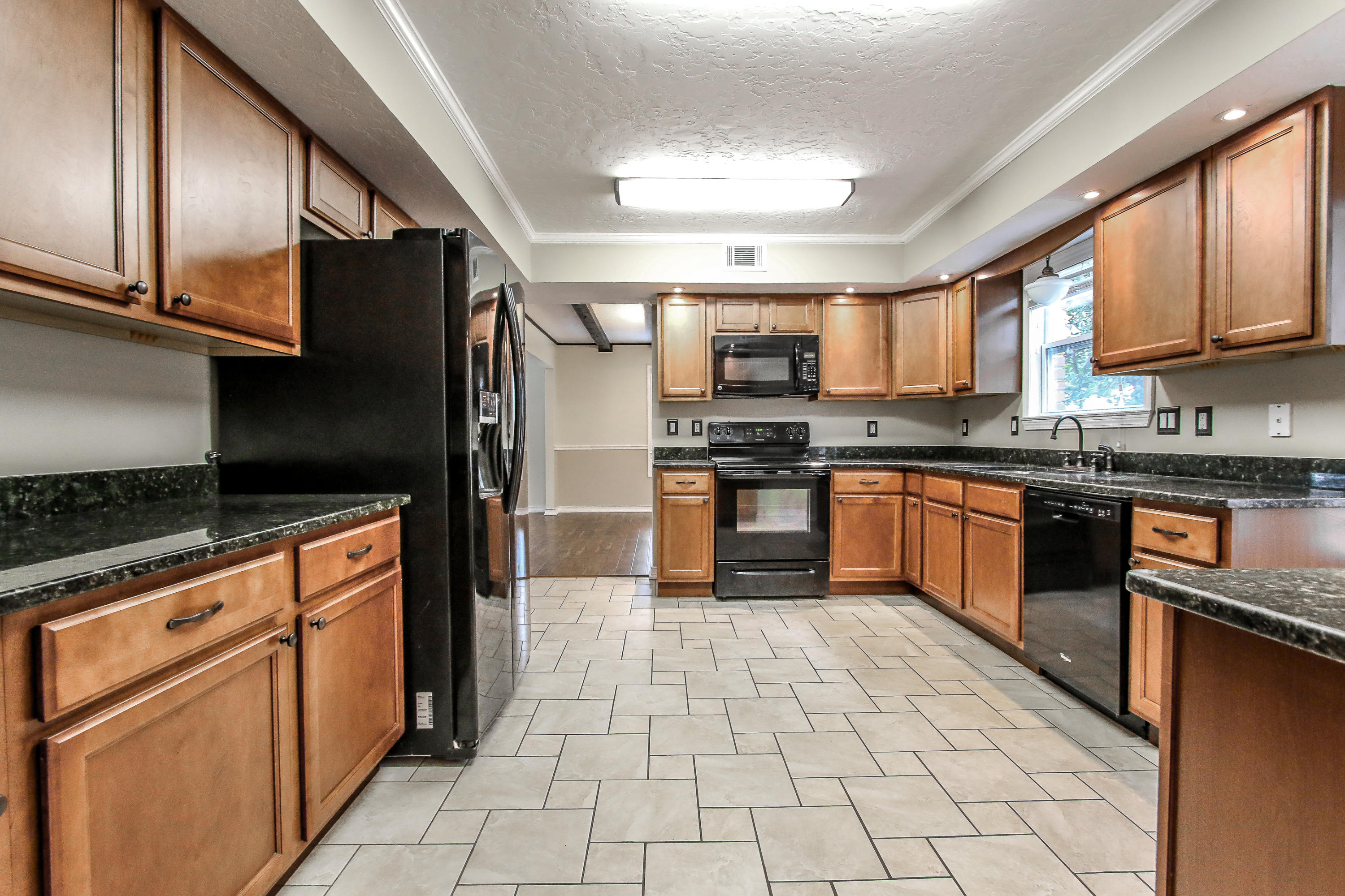 237 Country Club Road Shalimar, FL 32579 - Photo 31 of 74 a kitchen with stainless steel appliances granite countertop a stove top oven a sink dishwasher a refrigerator and cabinets with wooden floor