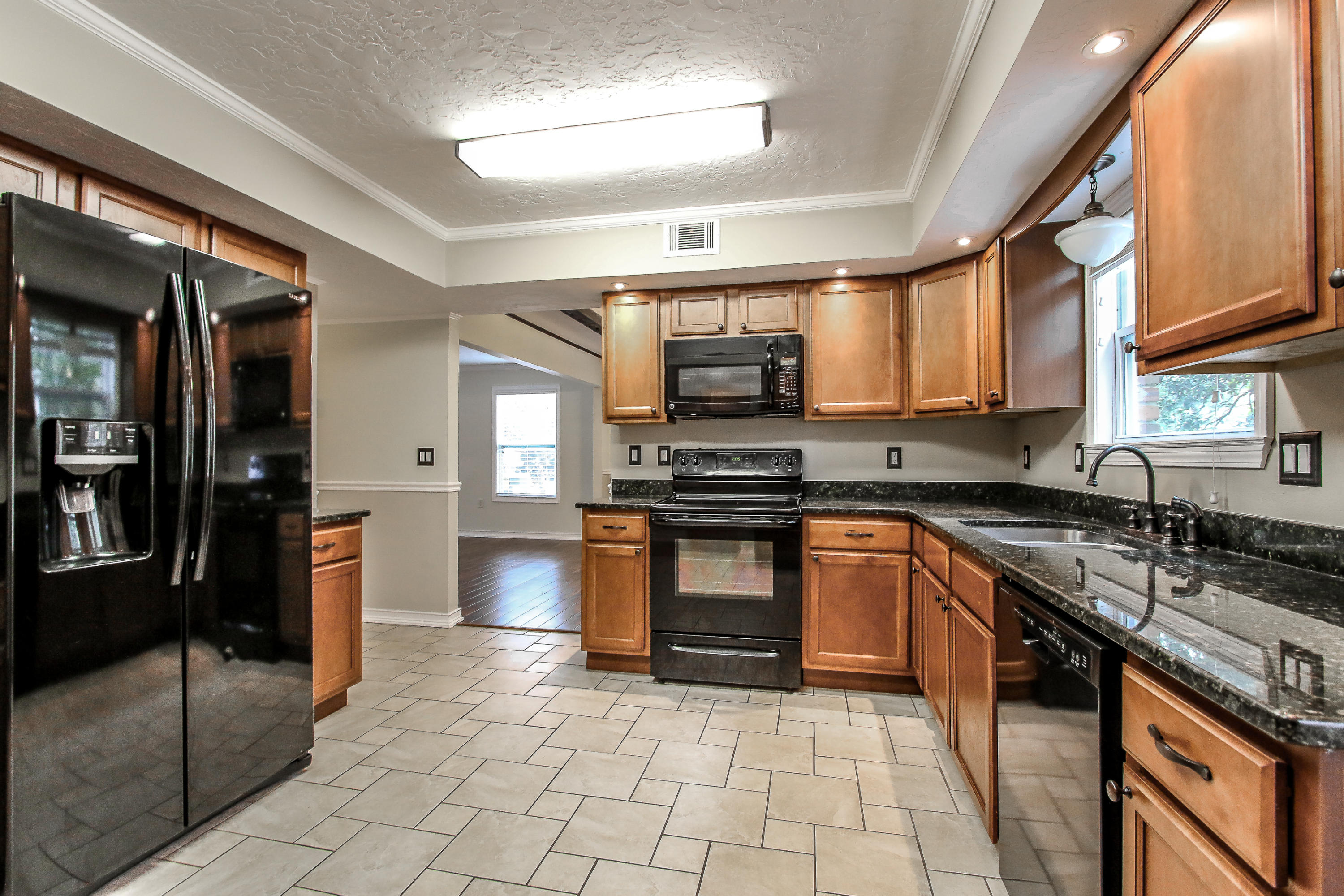 237 Country Club Road Shalimar, FL 32579 - Photo 32 of 74 a kitchen with stainless steel appliances granite countertop a stove sink and cabinets