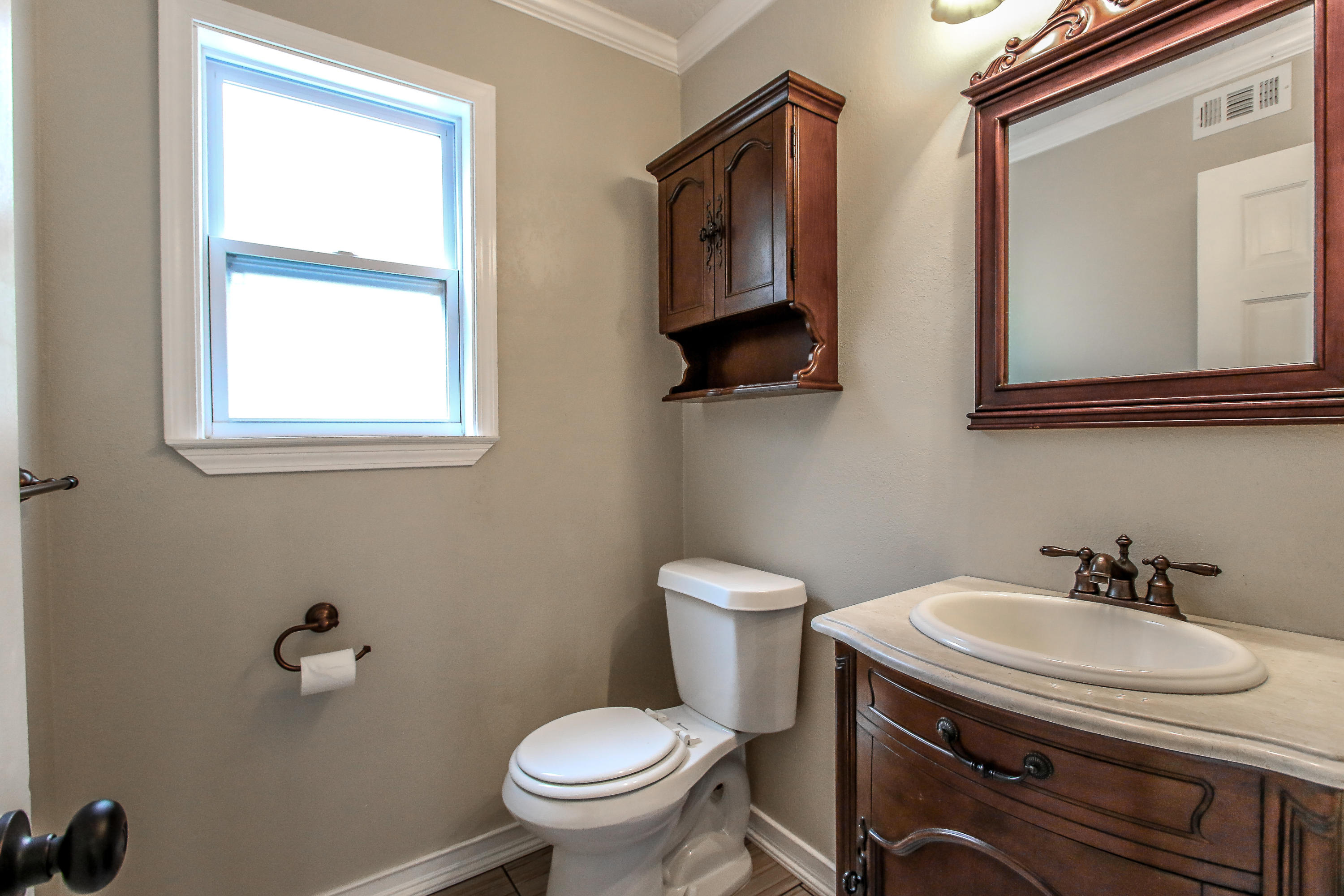 237 Country Club Road Shalimar, FL 32579 - Photo 38 of 74 a bathroom with a toilet a sink and mirror