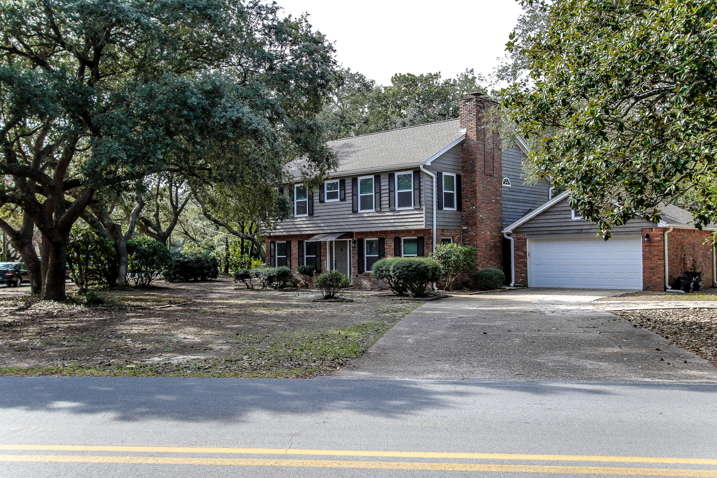237 Country Club Road Shalimar, FL 32579 - Photo 5 of 74 a front view of a house with a yard and garage