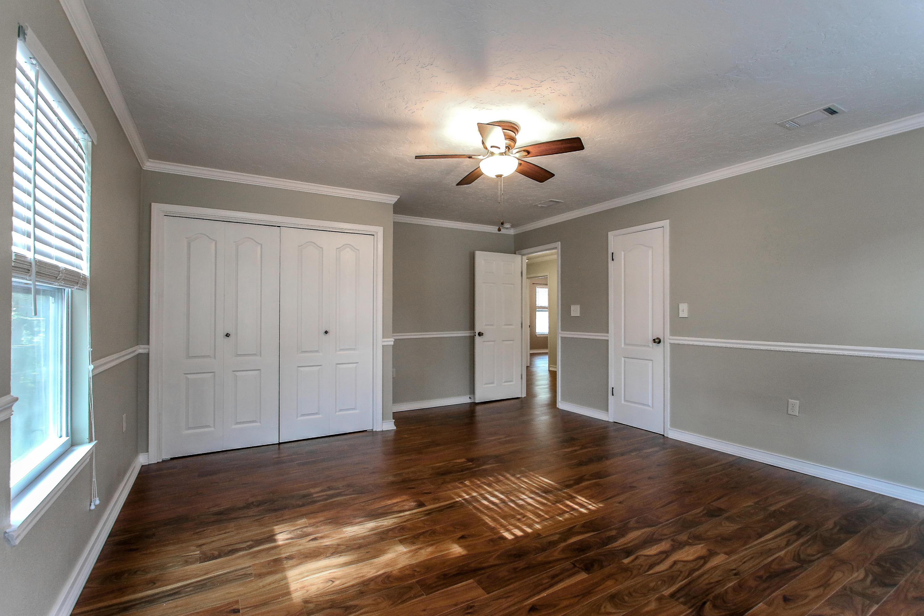 237 Country Club Road Shalimar, FL 32579 - Photo 51 of 74 a view of empty room with wooden floor and fan