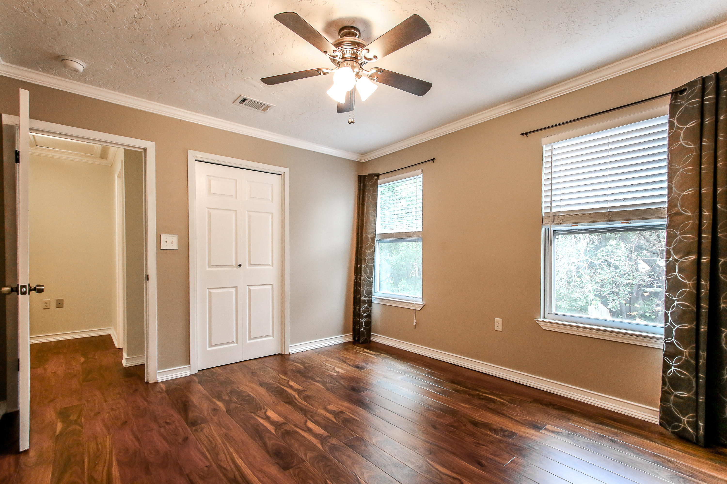 237 Country Club Road Shalimar, FL 32579 - Photo 59 of 74 a view of an empty room with window and wooden floor