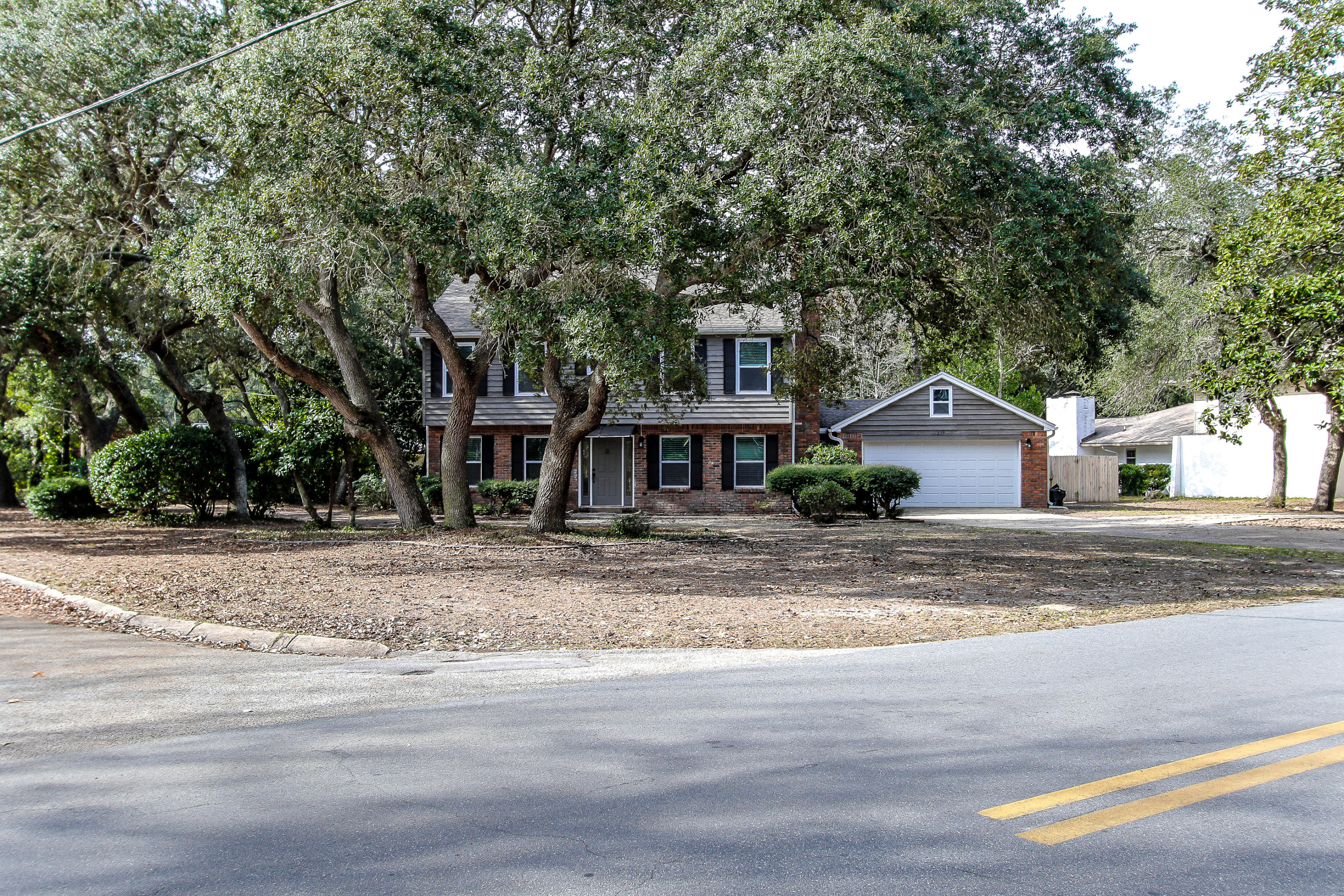 237 Country Club Road Shalimar, FL 32579 - Photo 6 of 74 a front view of a house with a yard
