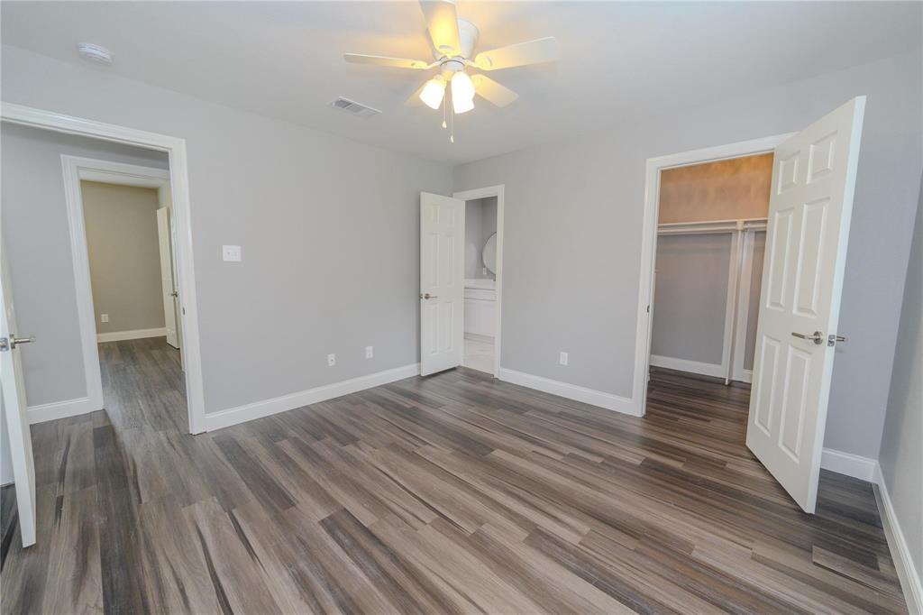 809 Wilcox Street McKinney, TX 75069 - Photo 13 of 26 Unfurnished bedroom featuring a spacious closet, dark wood-type flooring, and a ceiling fan