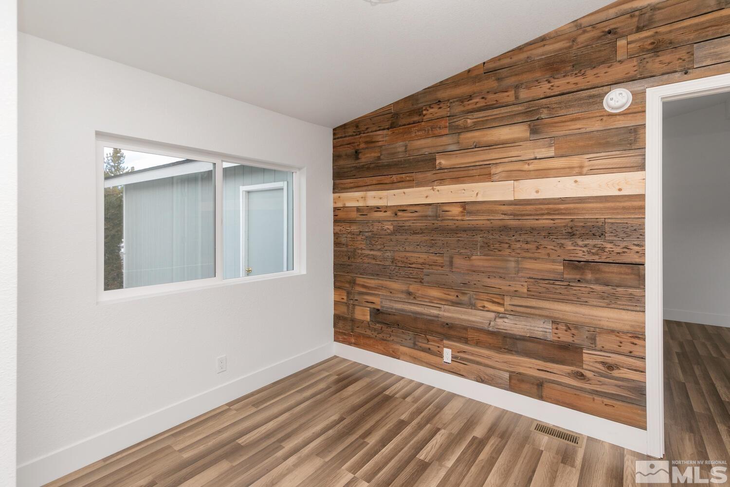 17530 Fantail Street Reno, NV 89508 - Photo 7 of 27 a view of room with wooden floor and a window