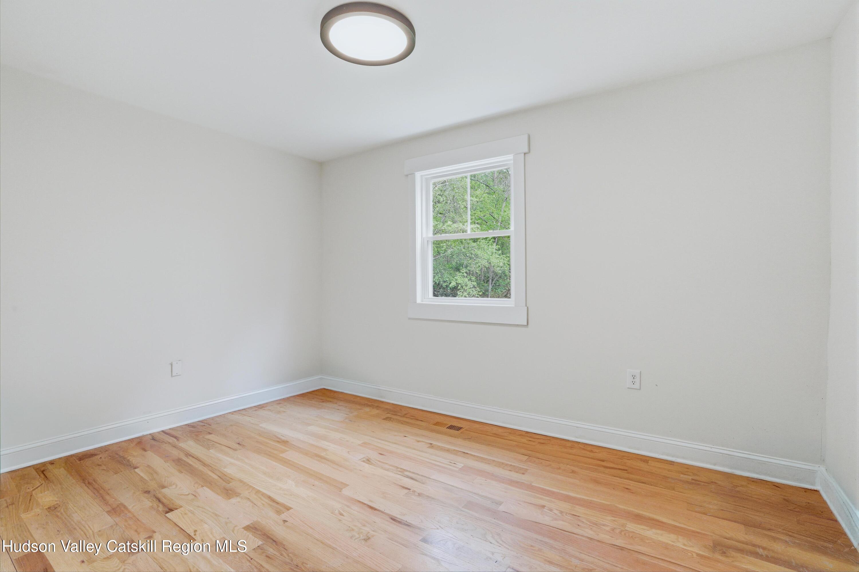 757 Taborton Road Sand Lake, NY 12153 - Photo 15 of 32 an empty room with wooden floor and windows