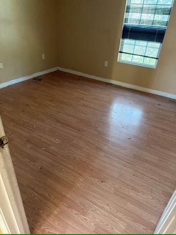 3470 Lawton Road Macon, GA 31204 - Photo 4 of 8 an empty room with wooden floor and windows