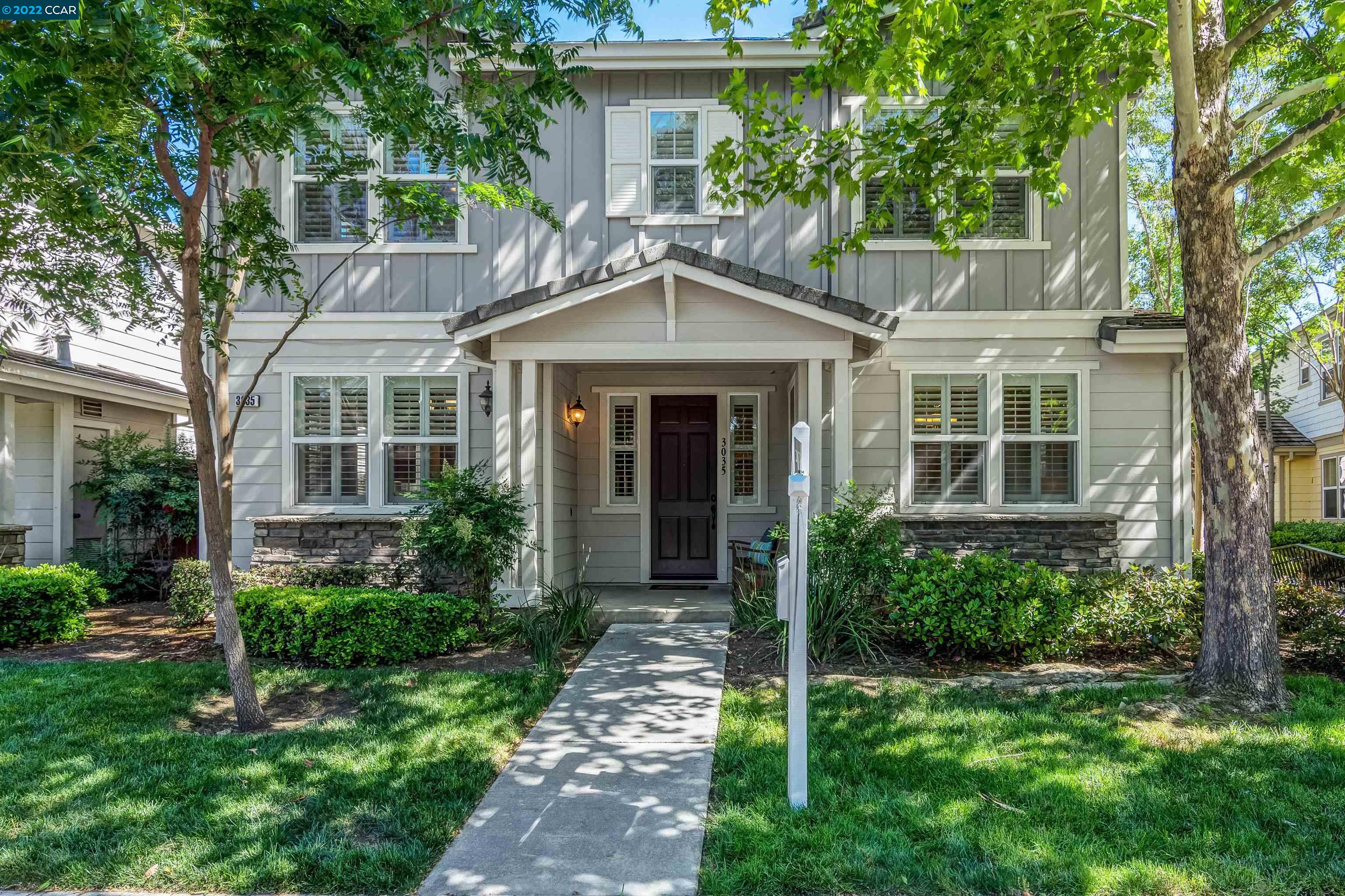 a front view of a house with a garden
