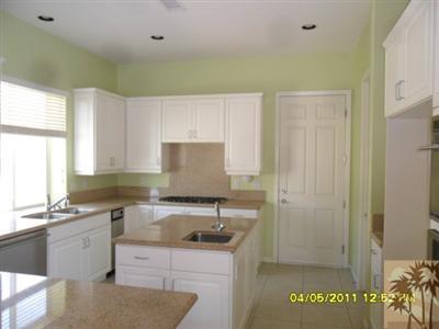 23 Napoleon Road Rancho Mirage, CA 92270 - Photo 3 of 7 a kitchen with a sink a stove and cabinets