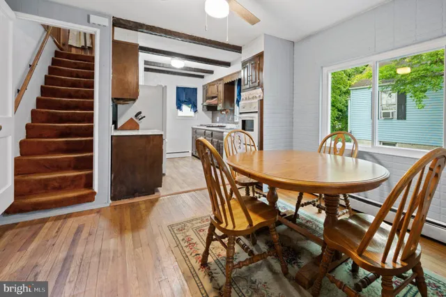 a dining room with furniture and wooden floor