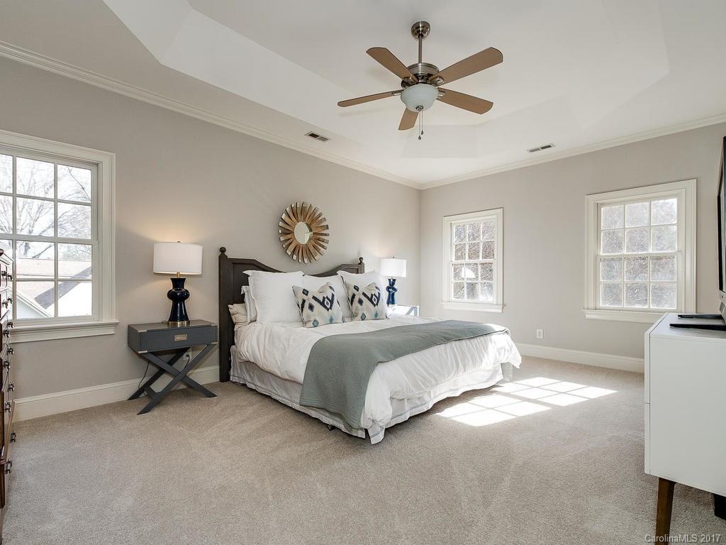 1900 Harris Road Charlotte, NC 28211 - Photo 12 of 24 a spacious bedroom with a bed a couch and a window