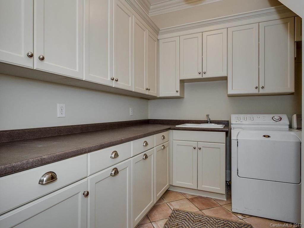 1900 Harris Road Charlotte, NC 28211 - Photo 10 of 24 a kitchen with white cabinets and white appliances