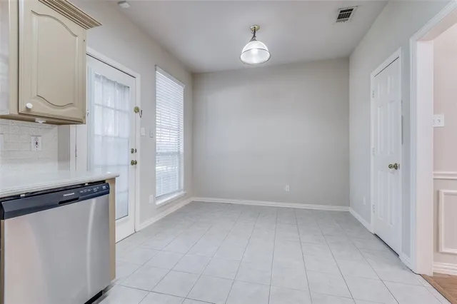 a view of a kitchen with white cabinets