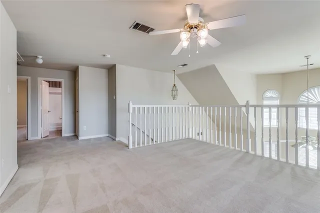 a view of a livingroom with a ceiling fan and window