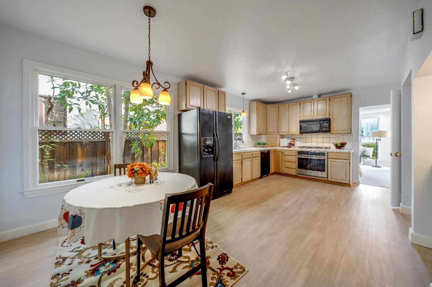 40 Bloomfield Road Burlingame, CA 94010 - Photo 21 of 45 a kitchen with stainless steel appliances granite countertop a stove a refrigerator a kitchen island a dining table and chairs