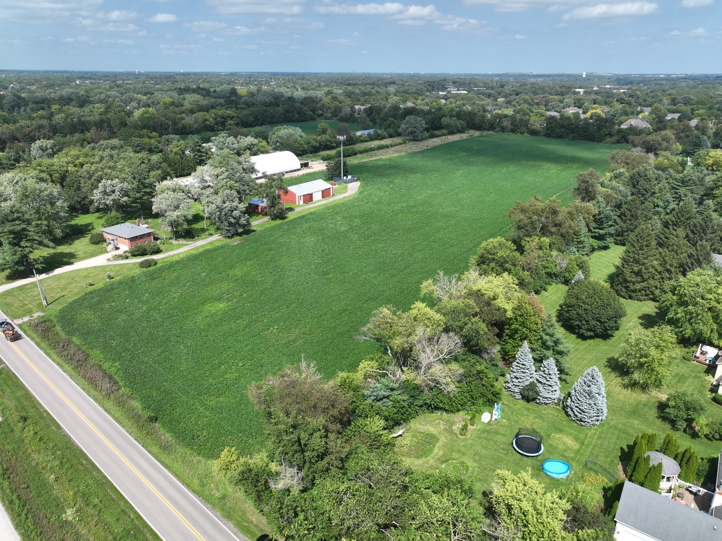 a view of a lake with a houses yard and green space