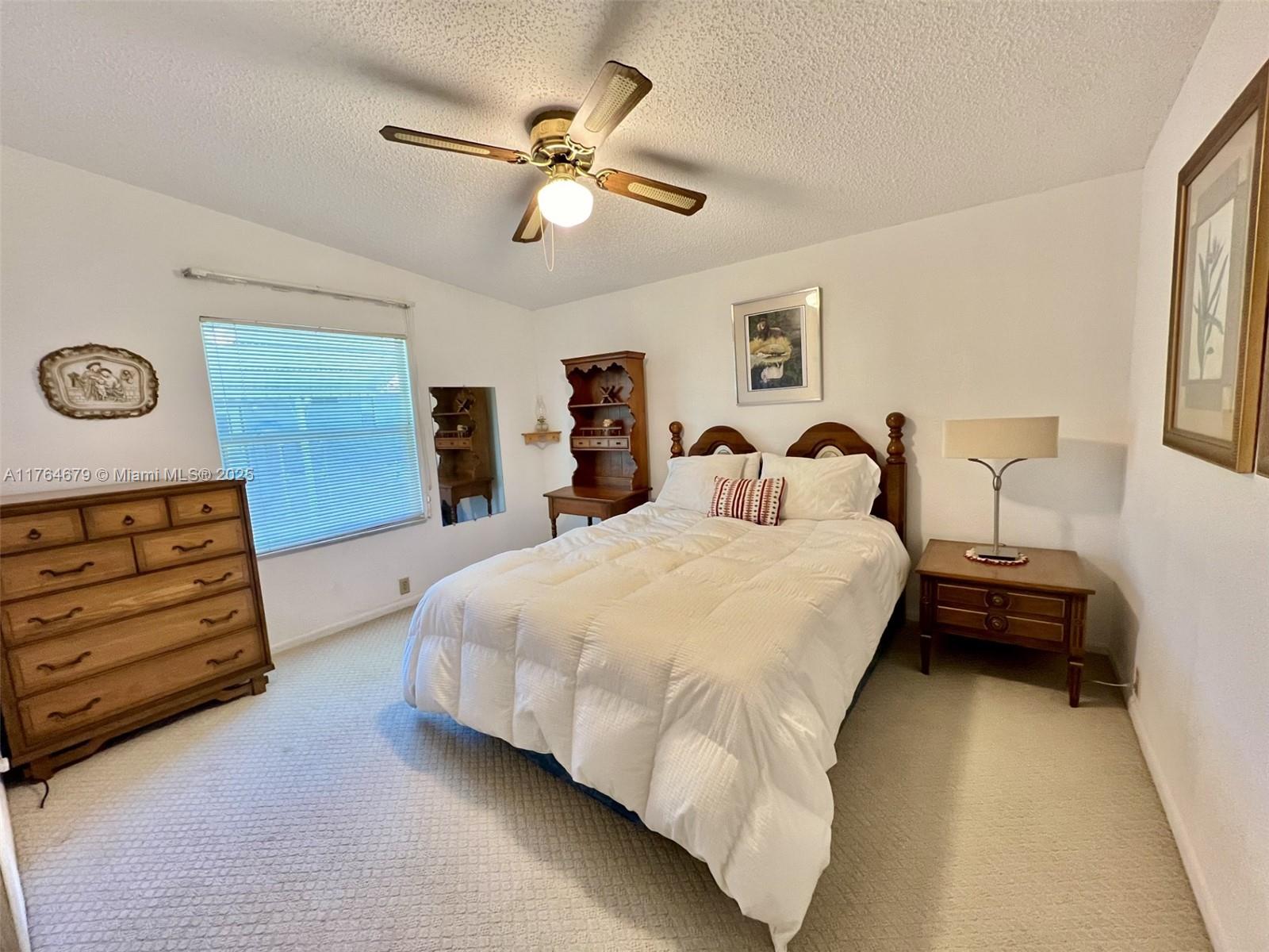 6367 Southwest 83rd Place Ocala, FL 34476 - Photo 15 of 47 a bedroom with a bed and a chandelier