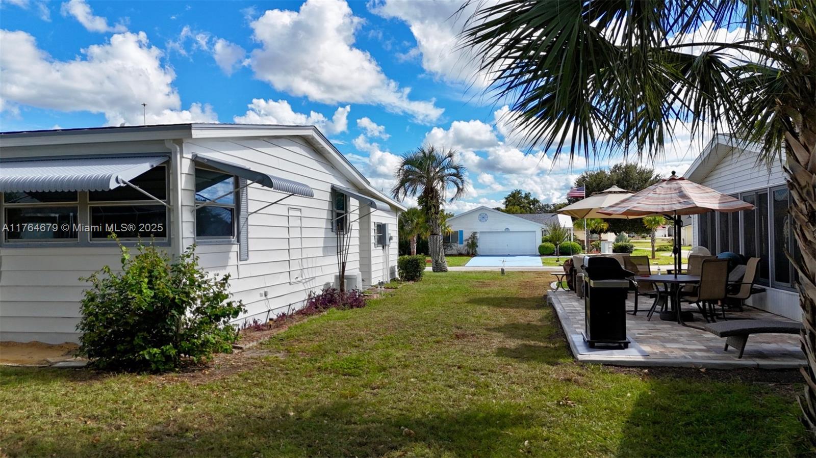 6367 Southwest 83rd Place Ocala, FL 34476 - Photo 3 of 47 a front view of a house with garden and sitting area