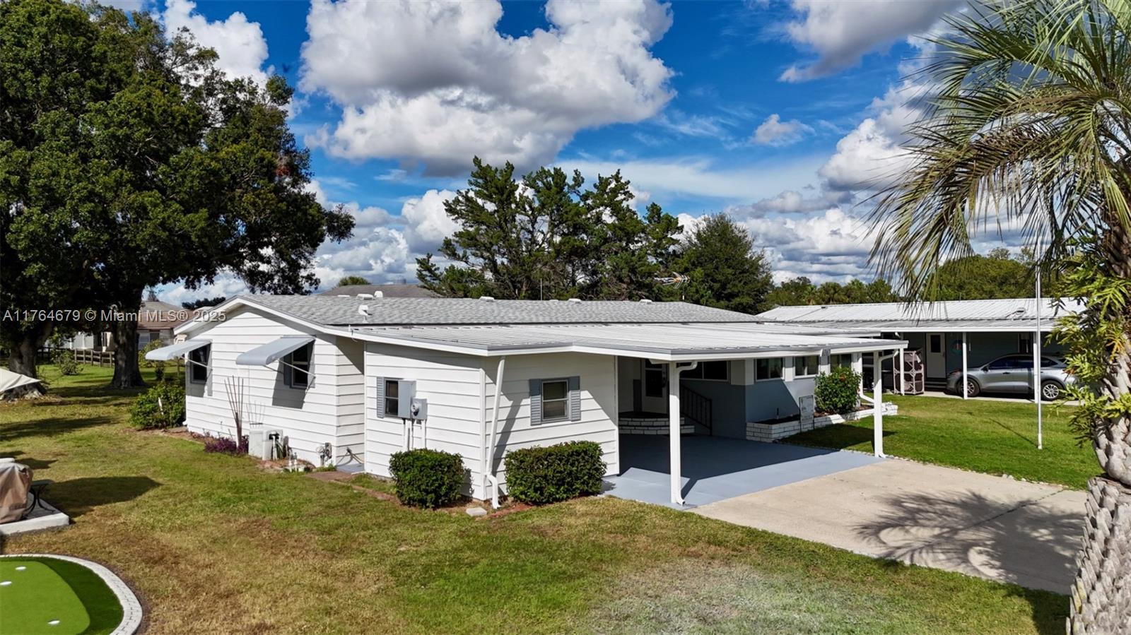 6367 Southwest 83rd Place Ocala, FL 34476 - Photo 6 of 47 front view of a house with a garden