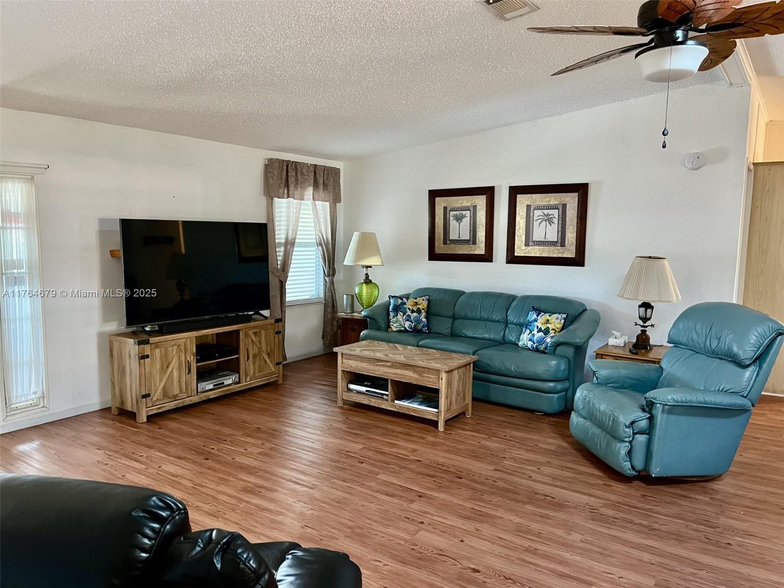 6367 Southwest 83rd Place Ocala, FL 34476 - Photo 10 of 47 a living room with furniture and a flat screen tv