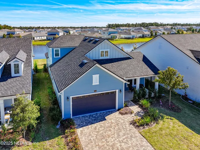 an aerial view of a house with a swimming pool outdoor seating and yard