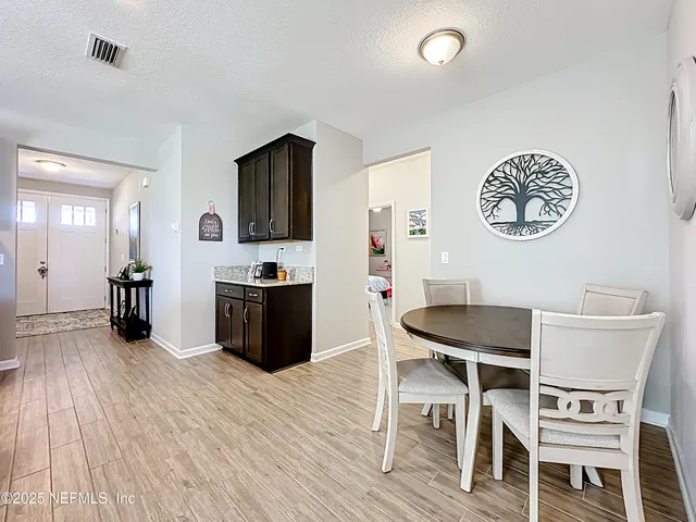 a kitchen with stainless steel appliances kitchen island granite countertop a stove top oven a sink and a refrigerator