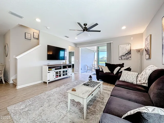a bedroom with a bed and a ceiling fan