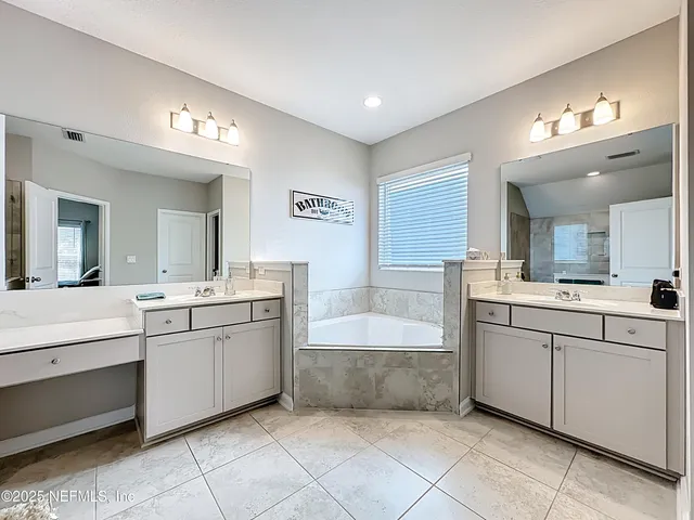 a view of a hallway with closet and wooden floor