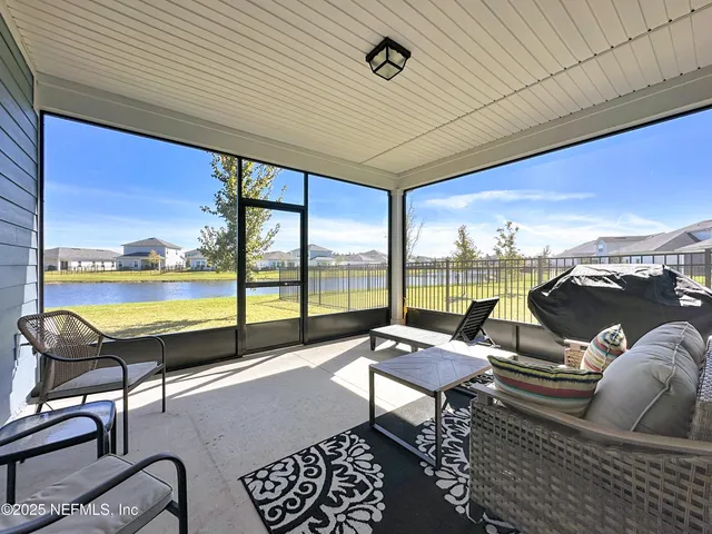 a roof deck with couch and chairs
