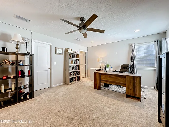 a view of residential houses with outdoor space and ocean view
