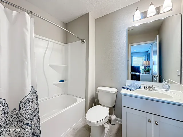 an aerial view of a house with a swimming pool an outdoor seating