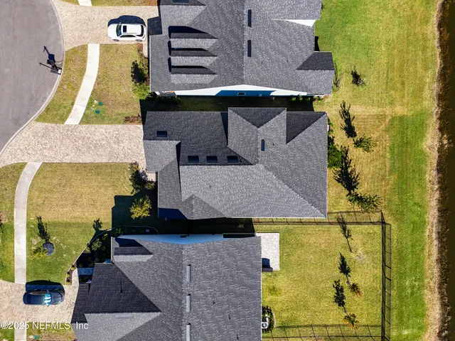 an aerial view of a house with a swimming pool yard and outdoor seating