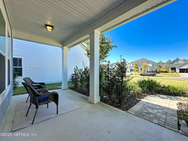 a view of a patio with table and chairs and potted plants
