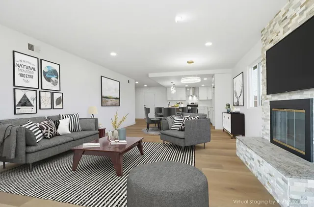 a living room with fireplace furniture and a flat screen tv