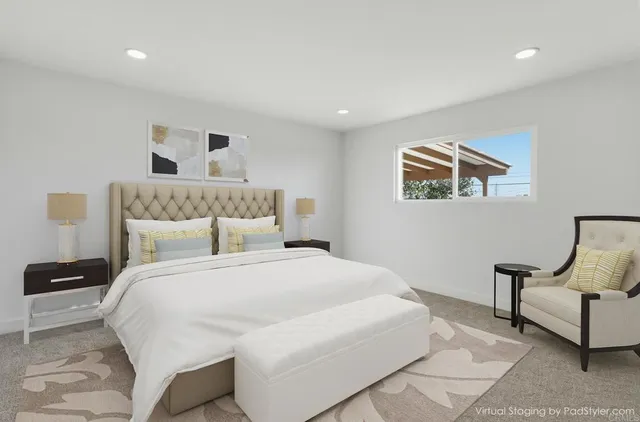 a bedroom with a large bed and a painting on the wall