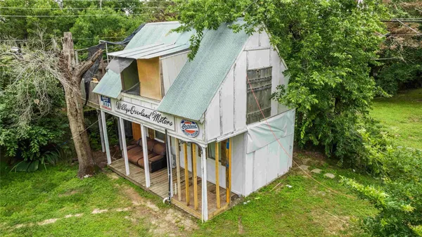 a view of a house with a yard and a garden